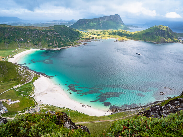 chalk-white sand and neon blue water of Haukland Beach viewed from Mannen peak, one of the easiest hikes in Lofoten