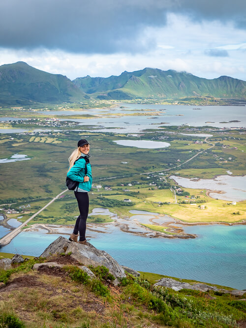 A woman standing on a rock on top of Offersøykammen mountain