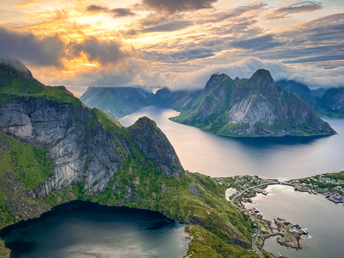 Soft golden light and dramatic mountains viewed from Reinebringen during Midnight Sun.