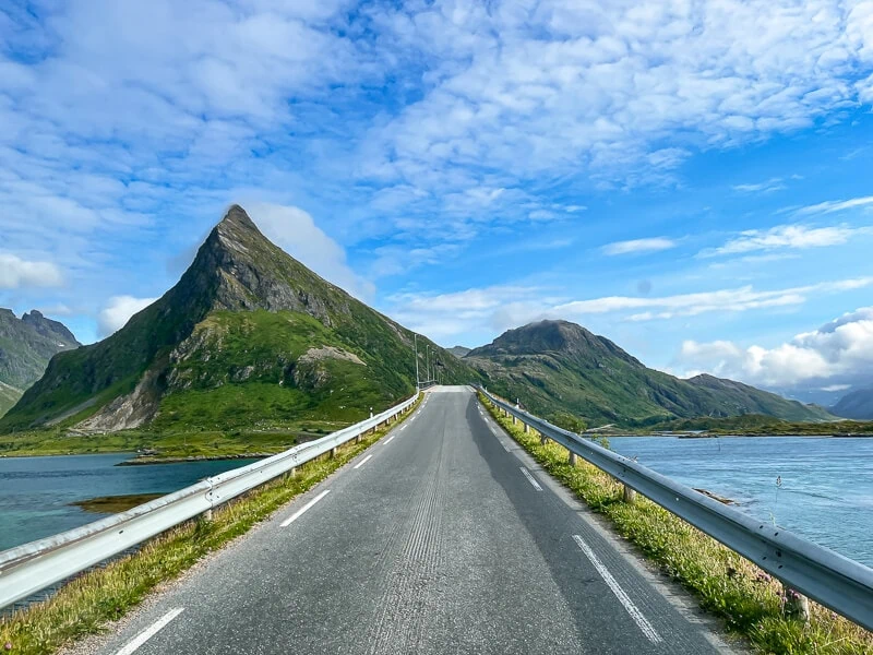 A narrow bridge surrounded by picturesque mountains on the Lofoten Islands