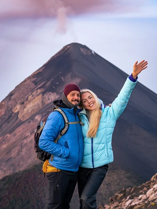 A couple posing in front of Fuego Volcano 