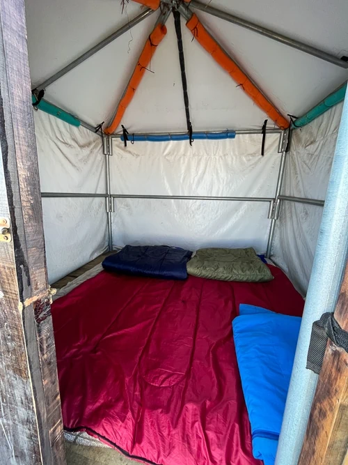 the inside of a 2-person tent with sleeping bags at Acatenango Base Camp