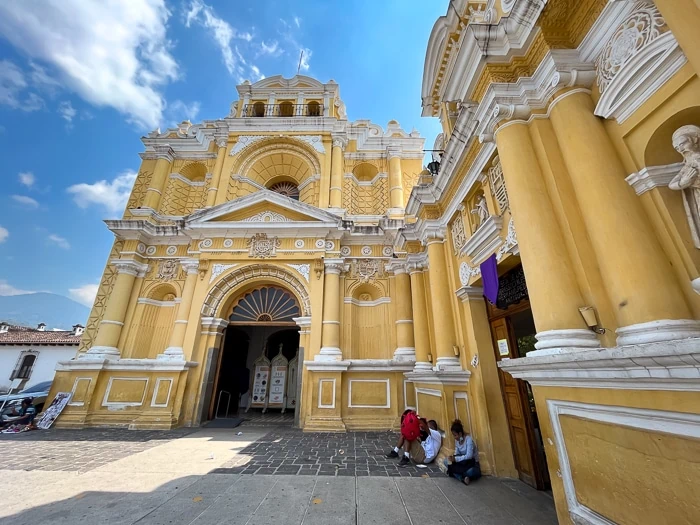 a church with a yellow facade with intricate details in Antigua