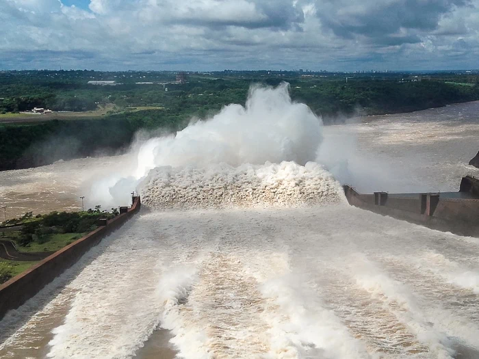 A large stream of gushing water released from the spillways at Itaipu Dam
