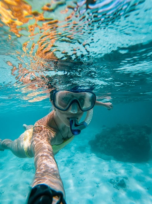 Me taking an underwater selfie while snorkeling in the clear blue waters of Koh Nang Yuan.