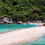 A white sandbank surrounded by turquoise sea and green vegetation at Koh Tao
