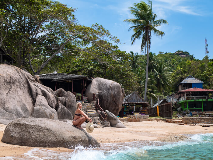 Me squatting on a large rock on the peaceful Sai Nuan Beach on the south coast of Koh Tao.