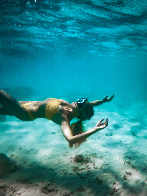 An underwater photo of me floating in the water, wearing my snorkeling mask.
