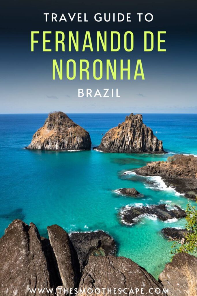 A Pinterest pin with an image of Morro Dois Irmaos rock formation in the turquoise ocean and a text overlay stating 'Travel guide to Fernando de Noronha, Brazil'.