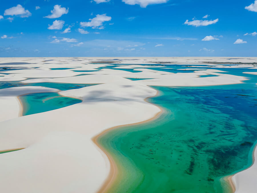 An aerial view of the powdery white sand dunes interlaced with turquoise freshwater ponds at Lençois Maranhenses.
