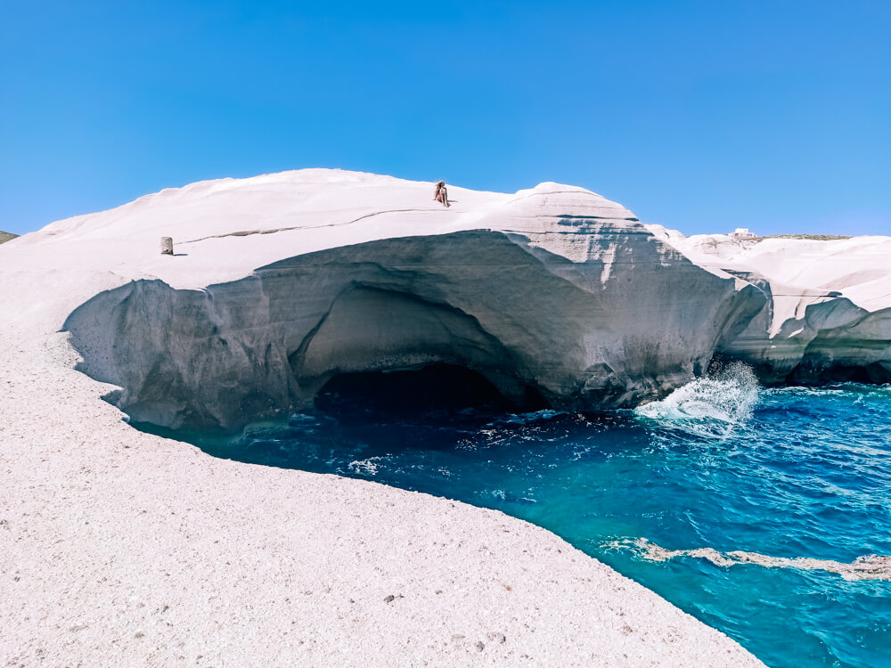The smooth white cliffs and turquoise sea at Sarakiniko Beach, a top attraction in Milos, Greece.